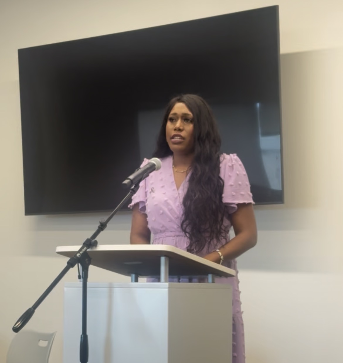 Jasmine Trevino speaking at a podium during a faith centered event