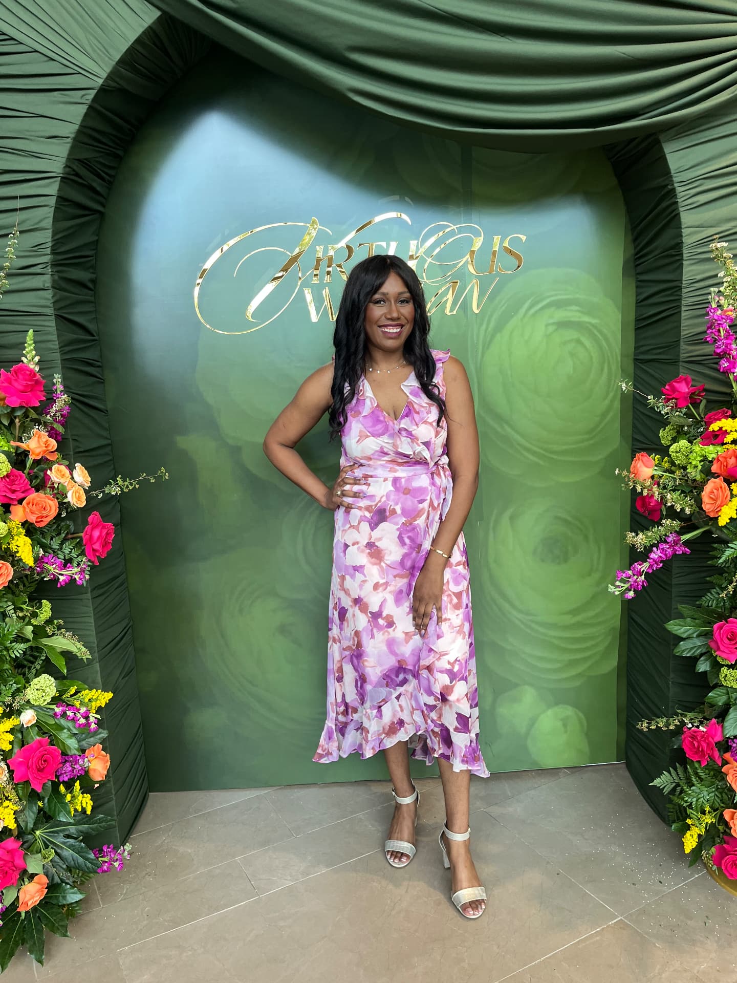 Jasmine Trevino, founder of Reclaimed Joy Coaching Services, smiling in a floral dress at a faith event